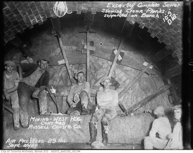 1927 - Sewers, excavation of complete sewer showing crown planks supported on bench, 10 foot 9 inch diameter - mining, west heading, contract 43, Russell Construction Company