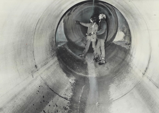 1975 - Andy Try, 14, and Peter Ostrowskie, 12, beam a flashlight down a side tunnel inside the network of storm sewers in Rexdale where some people believe missing 9-year-old Simon Wilson may be hiding. Brennan, Pat