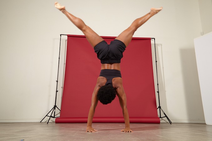 Andrea Carter doing gymnastics for a photoshoot by Stephanie Martyniuk, about empowering the females.