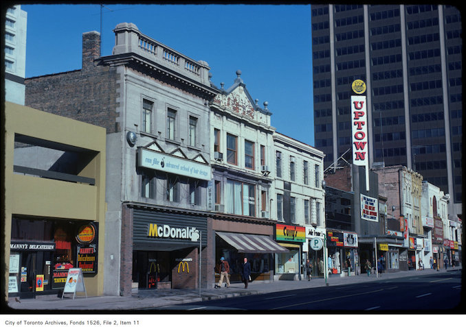 1975 - April 22 - View of stores along the west side of Yonge Street, south of Bloor Street West 2