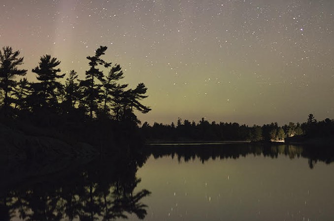 David Brown - My family has a cottage on Georgian Bay.  The original cottage was built by my great grandfather, my son is the 5th generation coming here.  It is a beautiful and rugged place that has shaped who I am and how I see the world.  This photo was take this August and shows the Northern lights shinning above the white pine horizon.