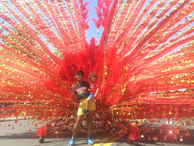 This is me with a giant Caribana costume with my son Brixton.