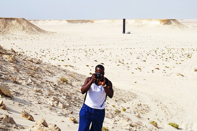 Ajani Charles photographing in Qatar's Zekreet Desert