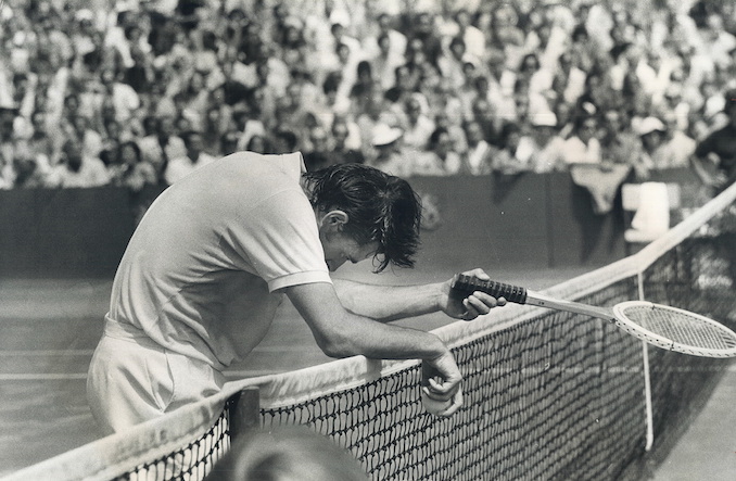 1970 - Run Ragged in men's singles final of Canadian Open Tennis Championships; a weary Roger Taylor of England rests for a moment against net