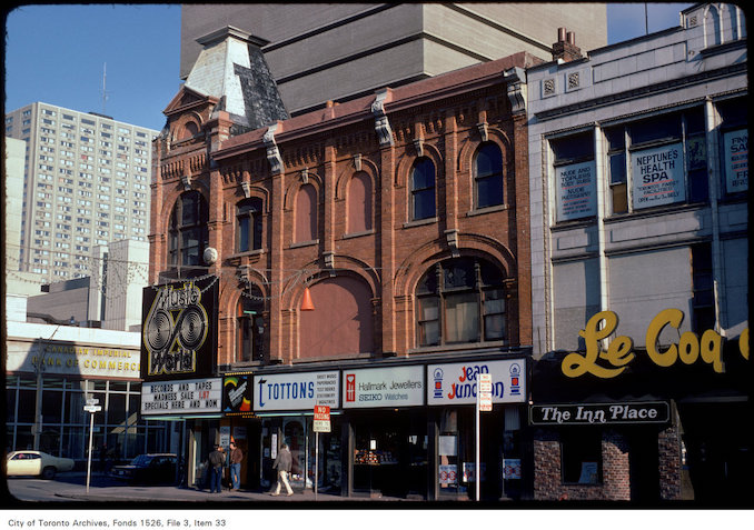 1975 - View of stores on the east side of Yonge Street at Gould Street