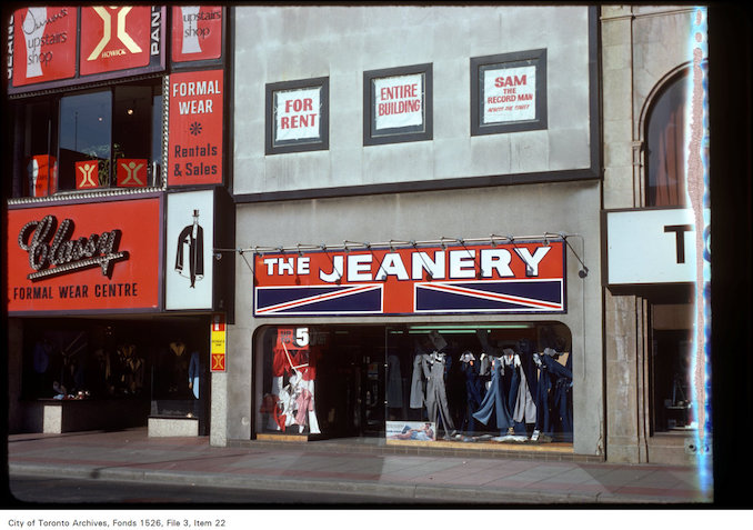 1977 - View of "the Jeanery" and "Classy" formal wear centre on Yonge Street, south of Walton Street