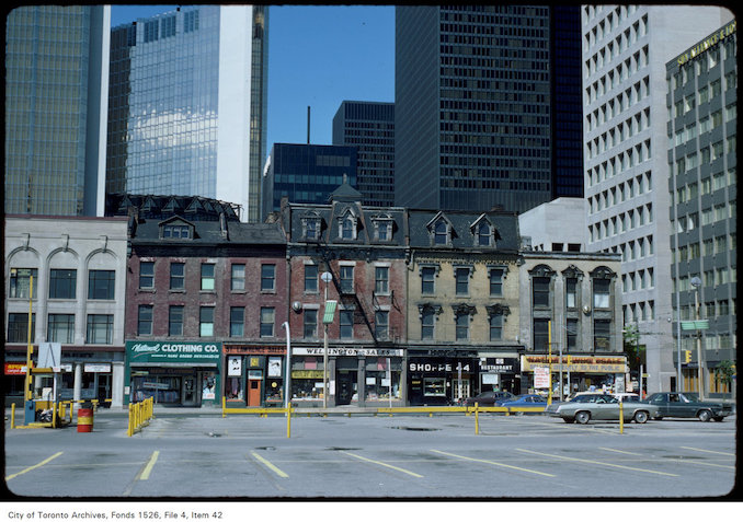 1977 - View of shops on the west side of Yonge Street south of Wellington