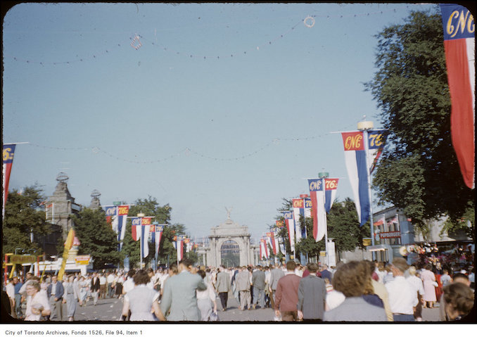 1954-August- Rear view of crowd entering the CNE through the Princes Gates