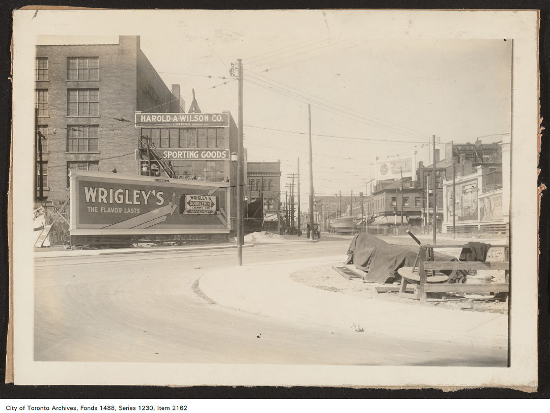 1920 - 1926 - billboard located on the north side of Dundas Street East, east of Yonge Street. View is looking south-east.