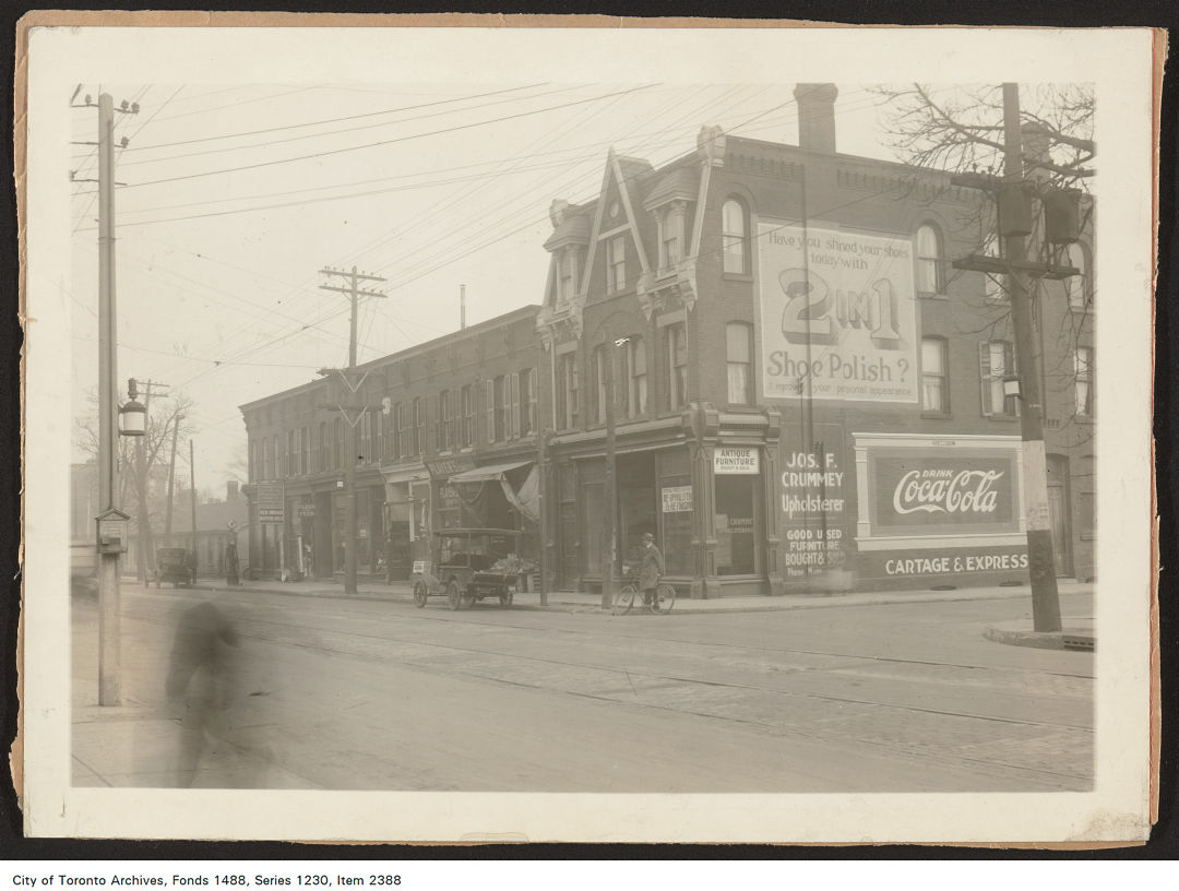 1920 - 1926 - photograph of two painted wall advertisements on the side of a building occupied by Joseph F. Crummey, Upholsterer, 377 Dundas Street East, at Ontario Street, south-east corner. 
