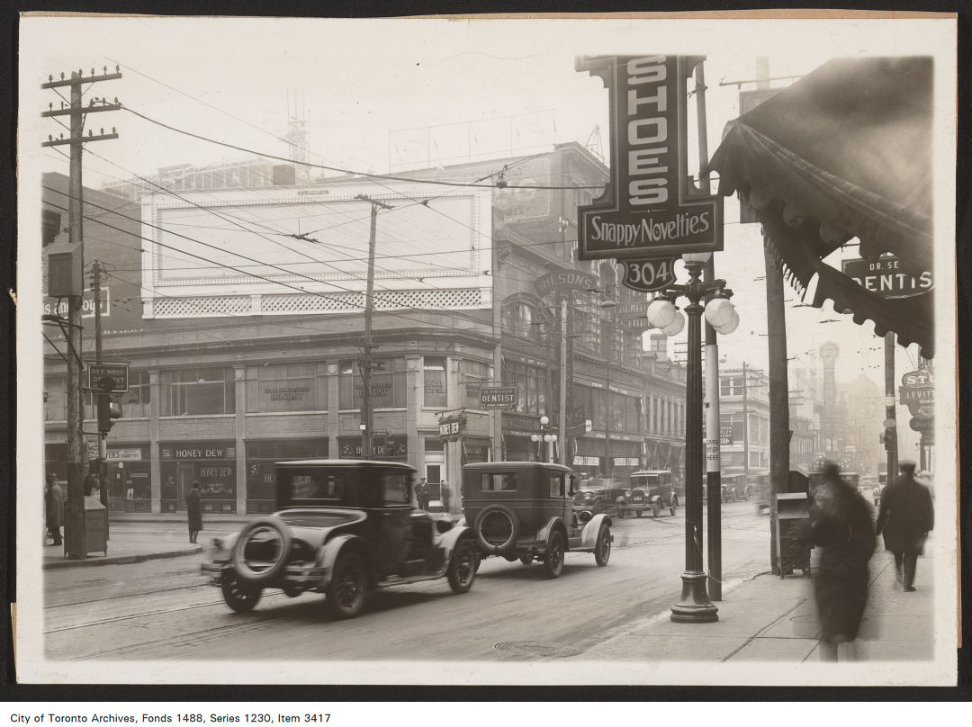 1929 - 1930 - photograph of a rooftop billboard location, Yonge Street, at Dundas Sttreet East, south-east corner. View is looking south-east.