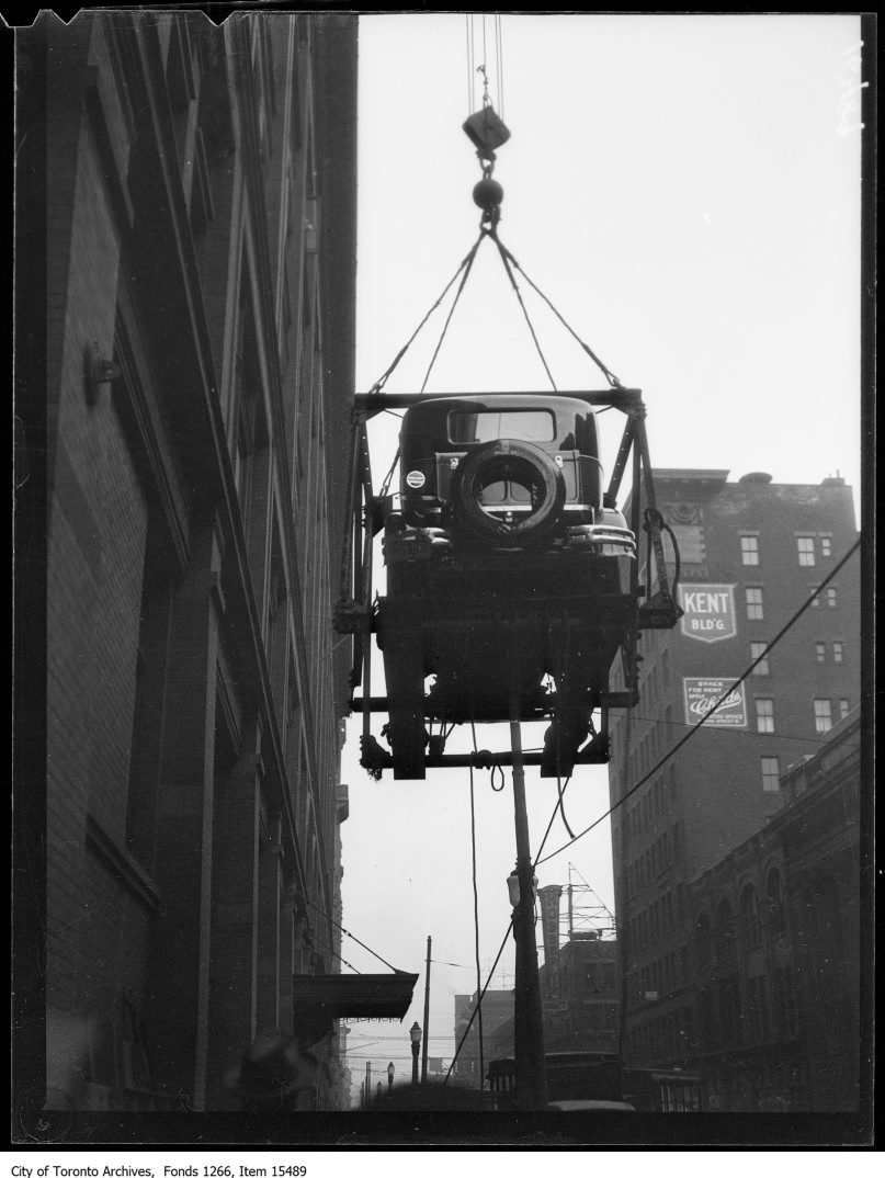 1929 - Motor Show, first car being hoisted, back, Simpson Building
