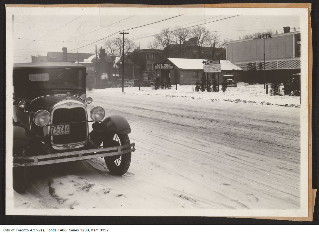 1929 - photograph of a billboard location overlooking a used car lot , located at Bay and Grosvenor streets