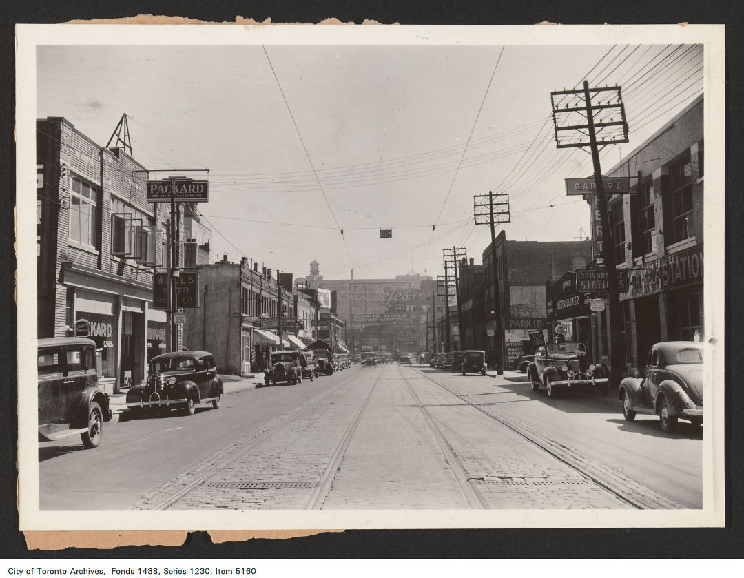 1937 - 1939 - photograph of a rooftop electric sign. View is looking east along Dundas Street West towards Yonge Street.