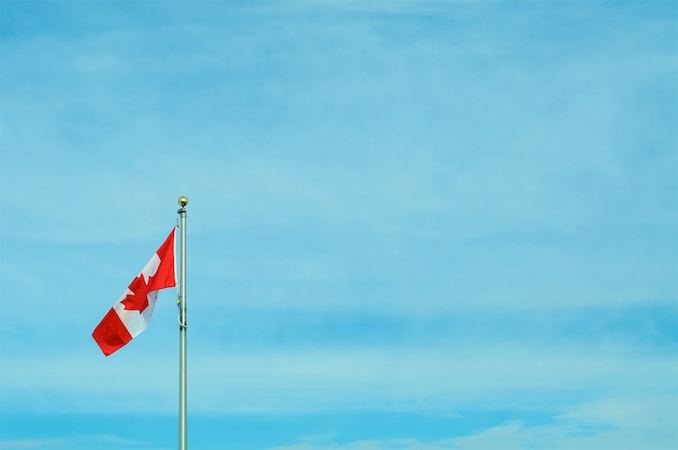 Canadian flag with blue sky background