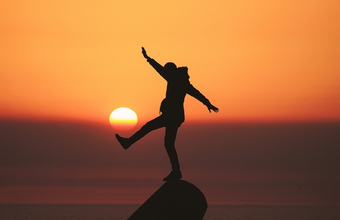 Sunset photo with person kicking the air in front