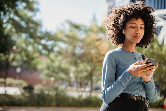 Woman using a smart phon in a park.