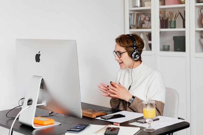 Woman using an apple desktop computer