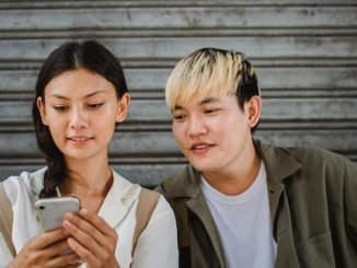 Two people looking at a smart phone for featured image