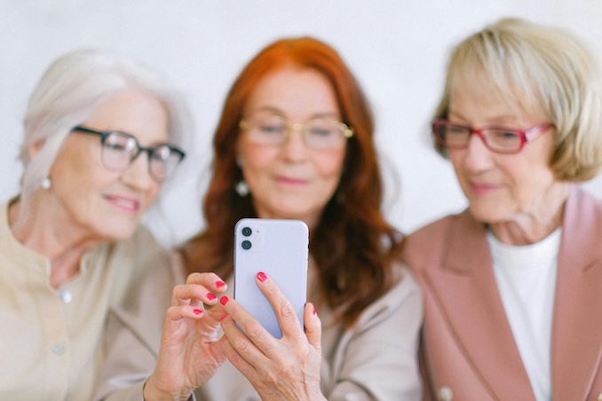 women using a cellphone together