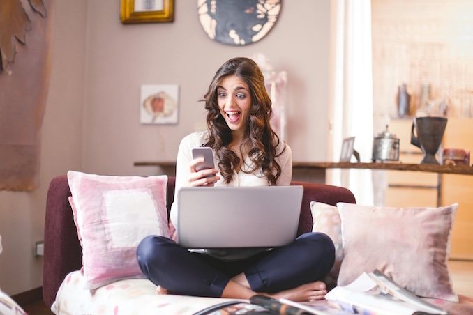 woman using cell phone and excited