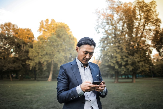 man using his cell phone to text