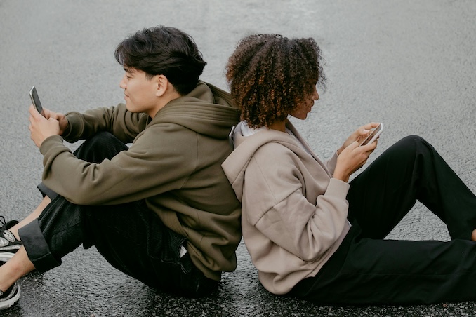 Two friends on phones
