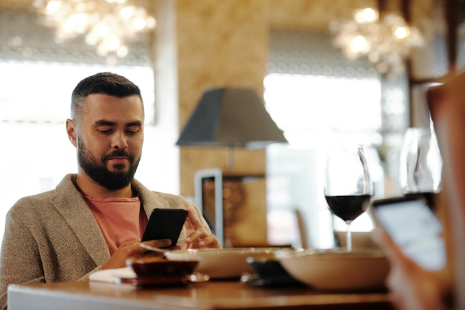 man texting on phone inside