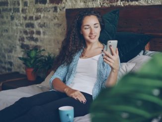 Women in bed on phone