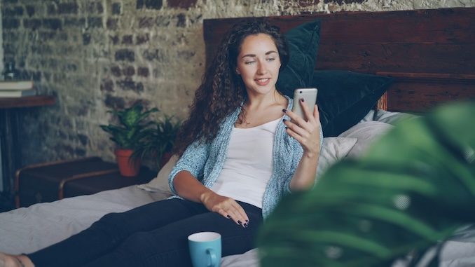 Women in bed on phone